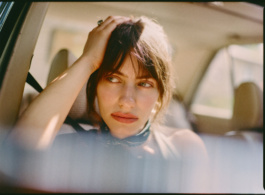 Woman in a car running fingers through her hair
