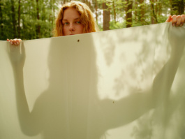 Woman's eyes peeking over the top of a large sheet
