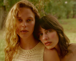 Close portrait of two women cheek to cheek outdoors