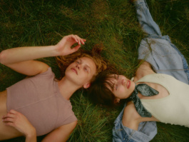Two people lying in grass seen from directly above